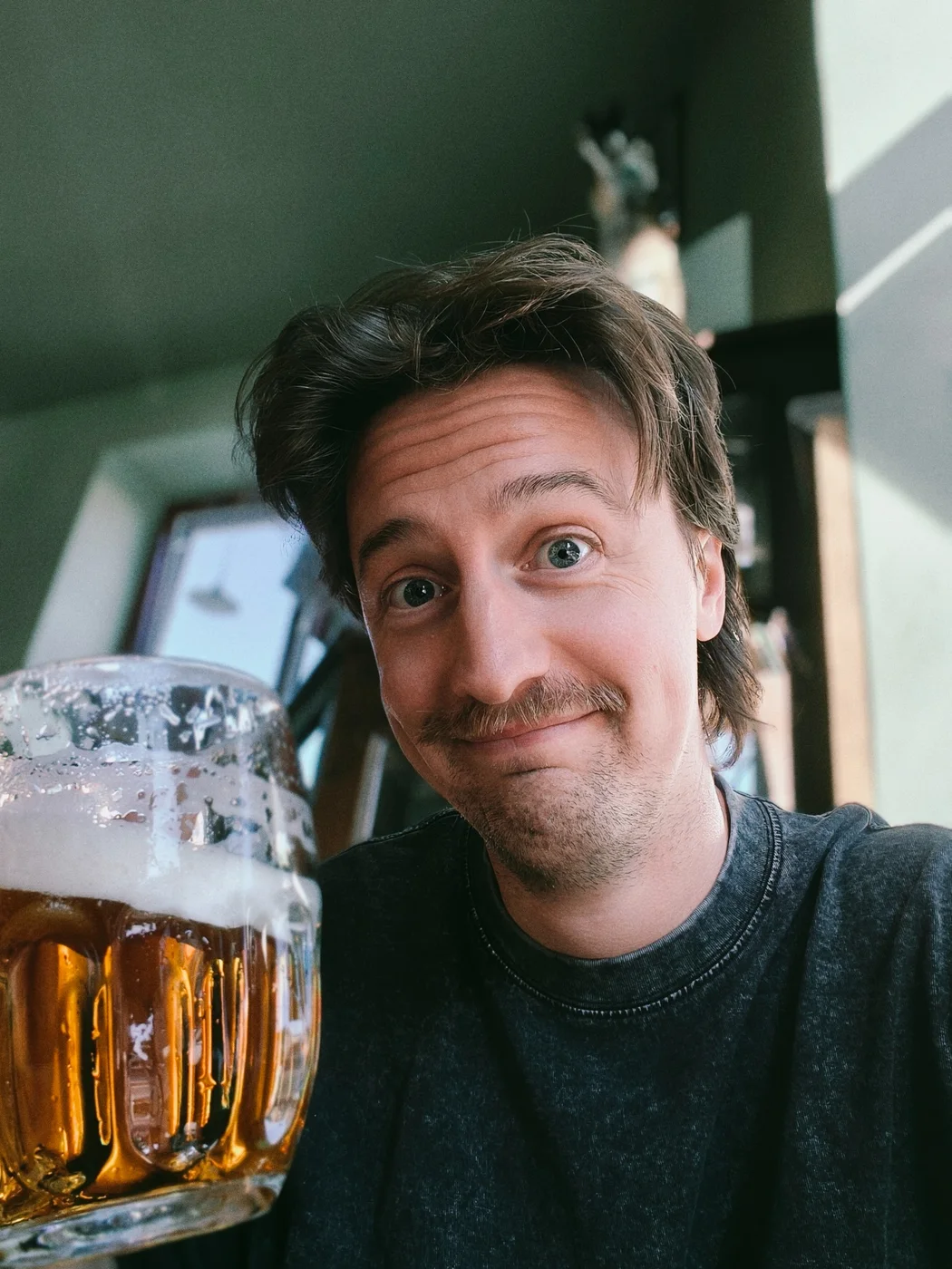 Emile Connaughton sitting outdoors with a beer